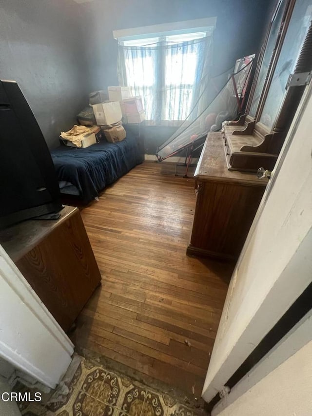 bedroom with dark wood-type flooring