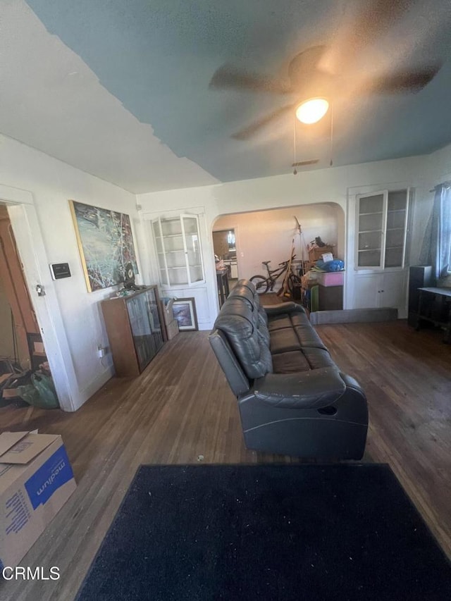 living room featuring built in features and hardwood / wood-style flooring