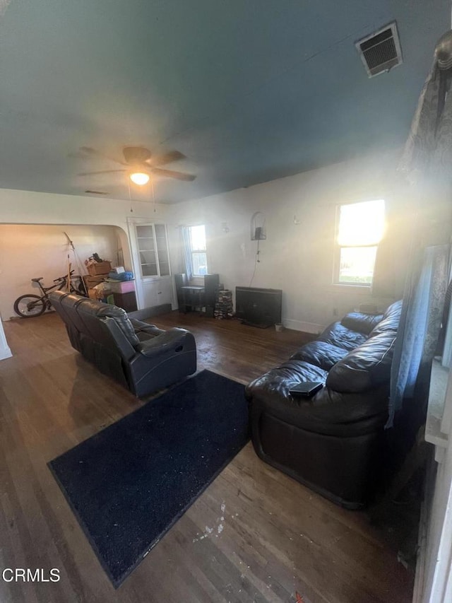 living room featuring ceiling fan, hardwood / wood-style floors, and a wealth of natural light