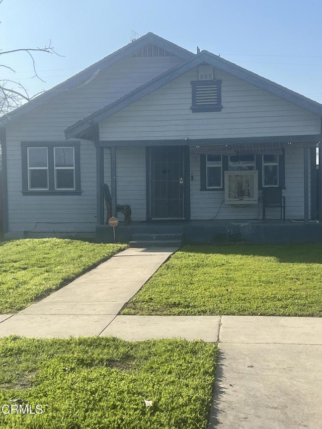 view of front of home with a porch and a front lawn