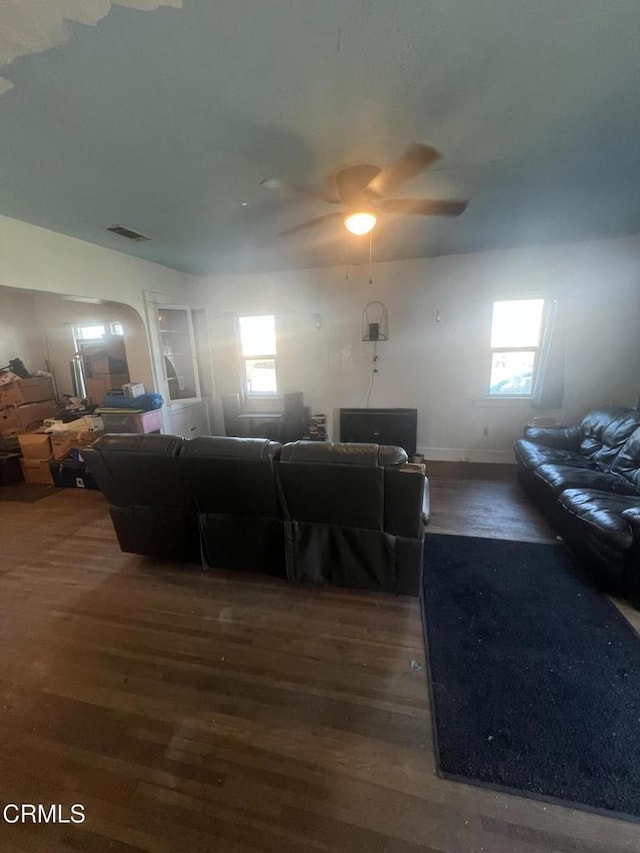 living room with ceiling fan and dark hardwood / wood-style floors