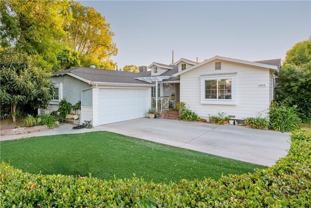 view of front of house with a garage and a front lawn