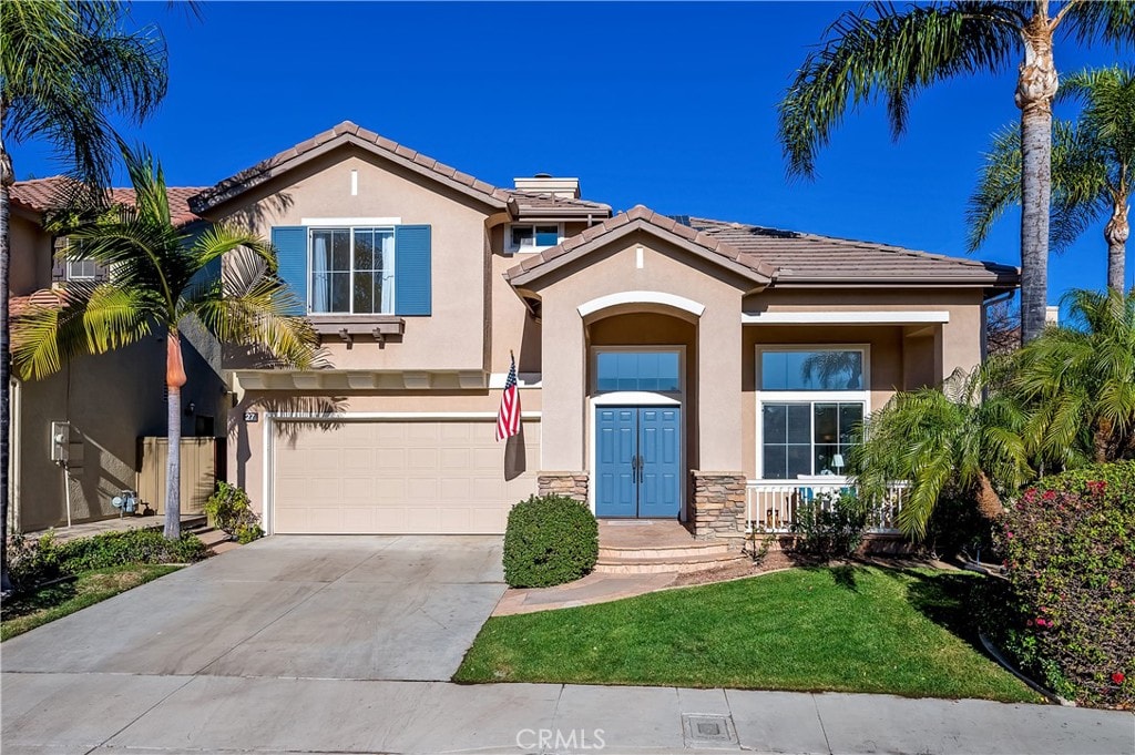 view of front of property with a front yard and a garage