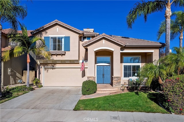 view of front of property with a front yard and a garage