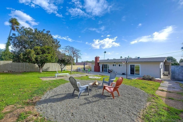 view of yard with a fire pit and a patio