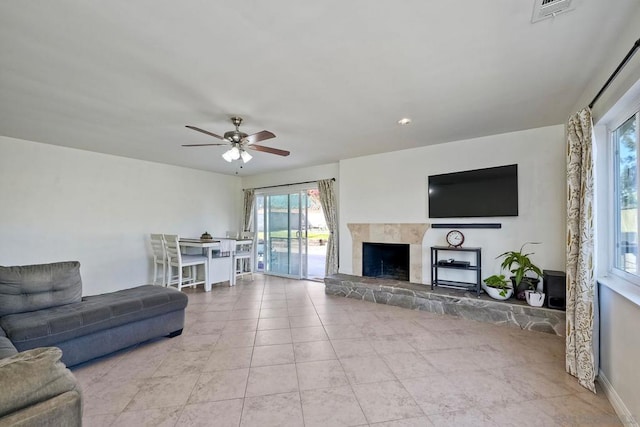 tiled living room with ceiling fan