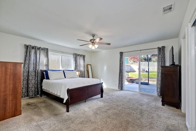 bedroom featuring ceiling fan, multiple windows, light carpet, and access to outside