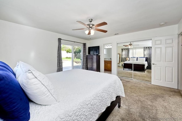 carpeted bedroom featuring ceiling fan, access to exterior, a closet, and ensuite bath