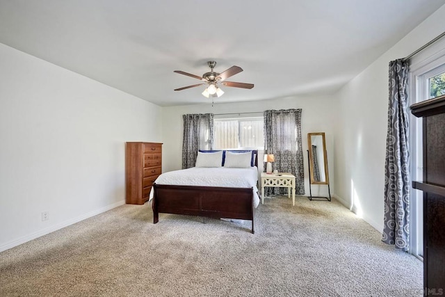 carpeted bedroom with ceiling fan and multiple windows