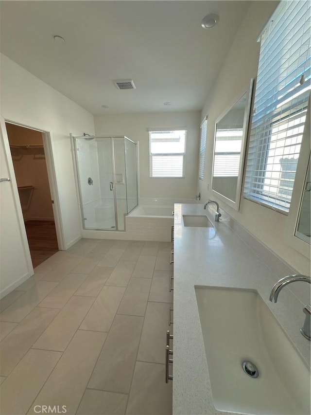 bathroom featuring vanity, independent shower and bath, and tile patterned flooring