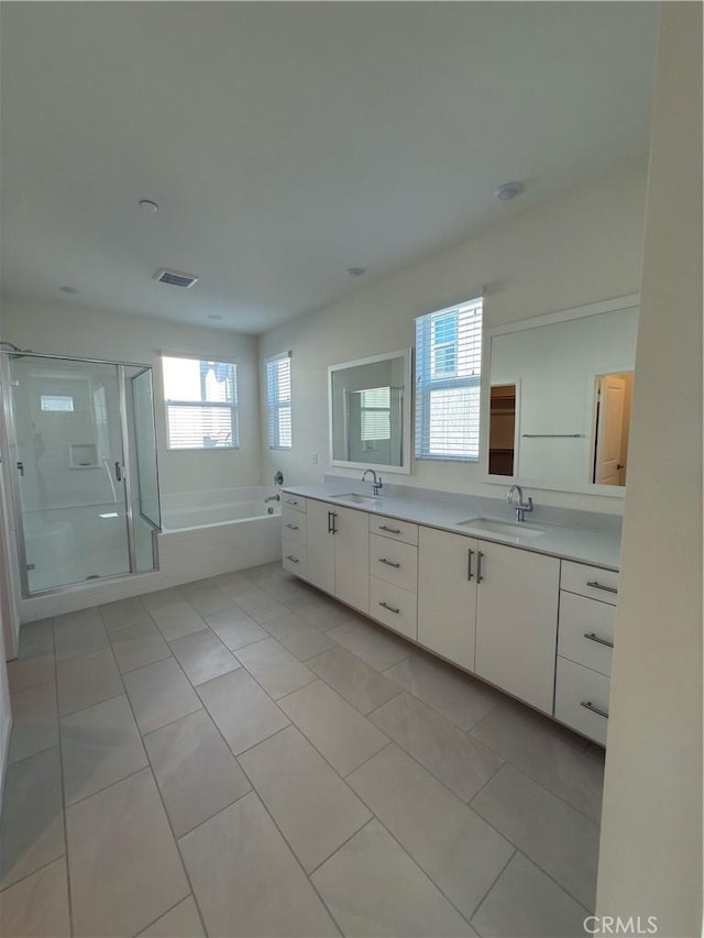 bathroom with plus walk in shower, tile patterned floors, and vanity