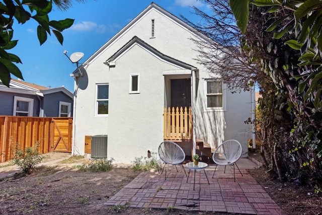 rear view of house featuring a patio and central AC unit