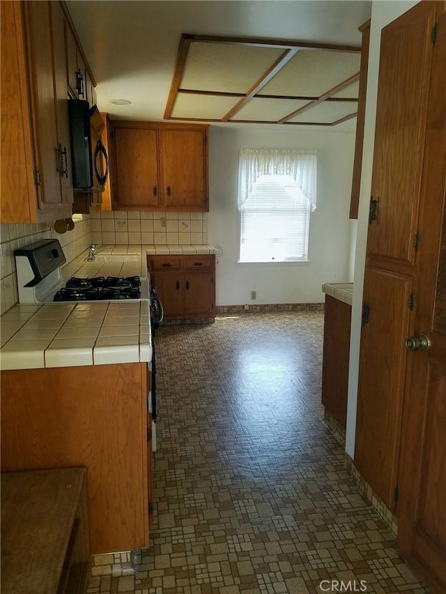 kitchen with backsplash and tile countertops