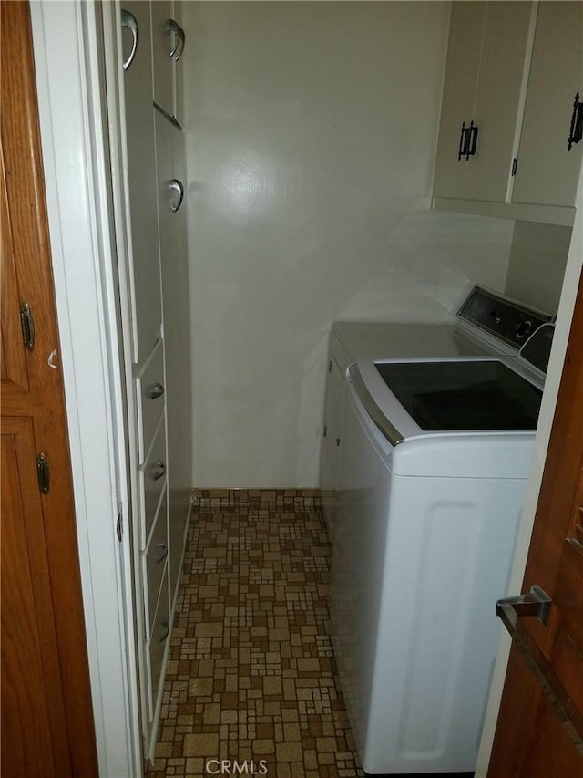 laundry room featuring cabinets and separate washer and dryer