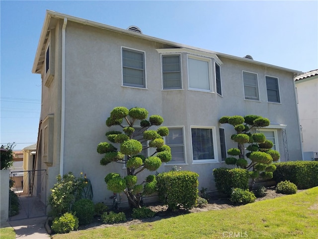 view of side of home featuring a yard