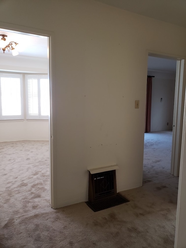 hallway with light colored carpet