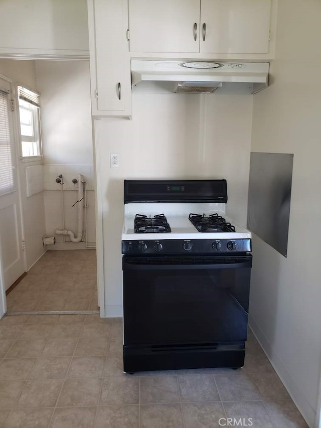 kitchen featuring white cabinetry, light tile patterned floors, and black range with gas cooktop