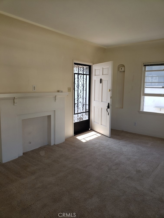 unfurnished living room with carpet