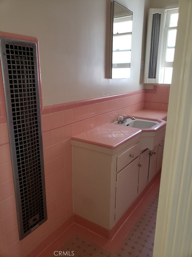 bathroom featuring tile walls and vanity