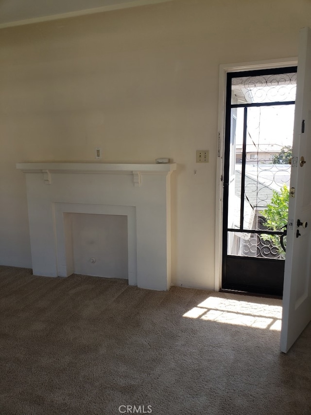 unfurnished living room featuring carpet floors