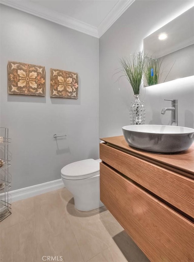 bathroom featuring toilet, ornamental molding, tile patterned floors, and vanity