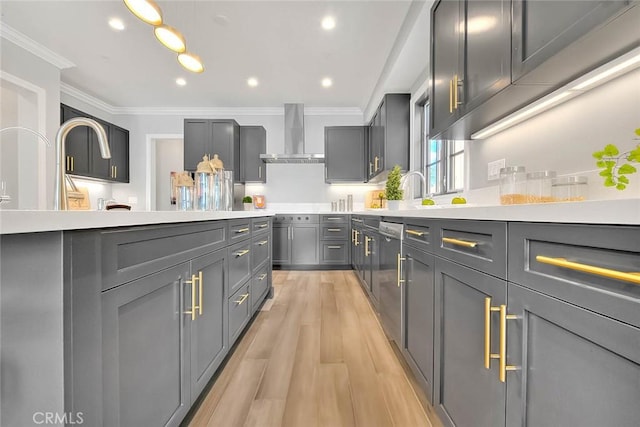 kitchen with gray cabinets, dishwasher, ornamental molding, wall chimney exhaust hood, and light hardwood / wood-style flooring