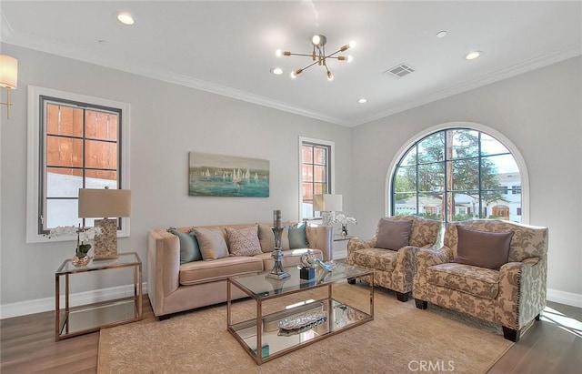 living room featuring a chandelier, ornamental molding, and hardwood / wood-style flooring