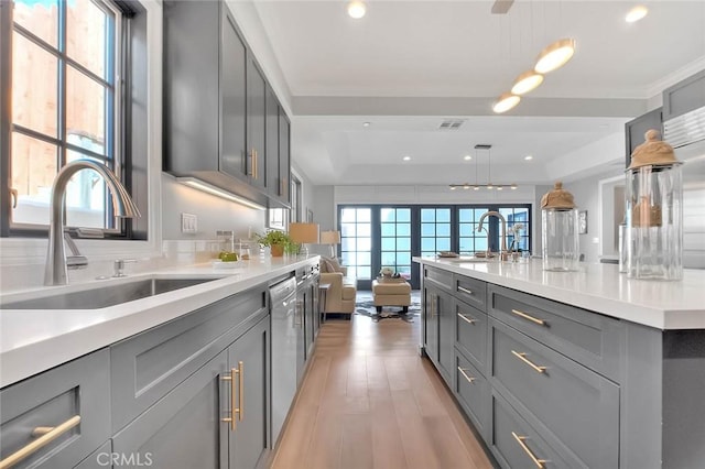 kitchen with decorative light fixtures, sink, and gray cabinetry