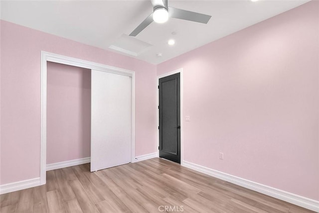 unfurnished bedroom featuring ceiling fan, a closet, and light hardwood / wood-style floors