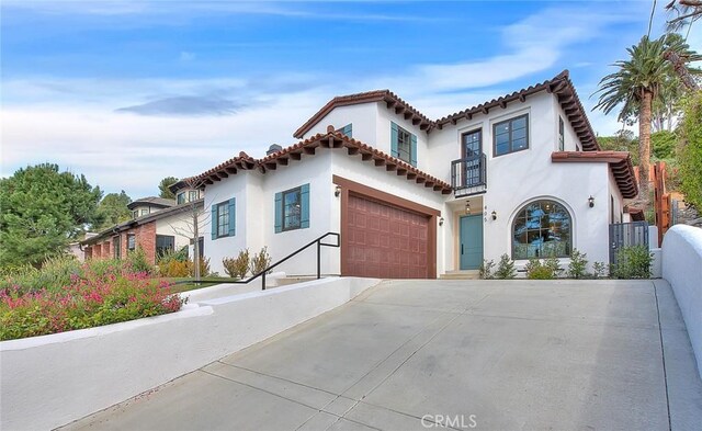 mediterranean / spanish-style house featuring a garage