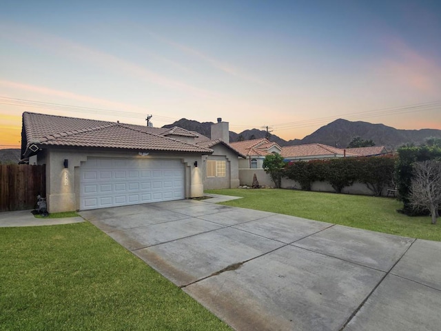 single story home with a mountain view and a yard