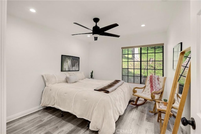 bedroom with ceiling fan and light hardwood / wood-style floors