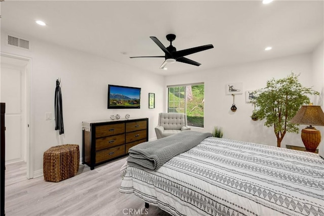 bedroom with ceiling fan and light hardwood / wood-style flooring