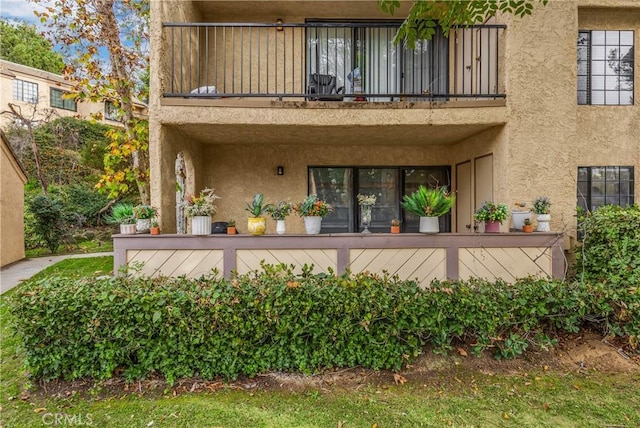 rear view of property with a balcony