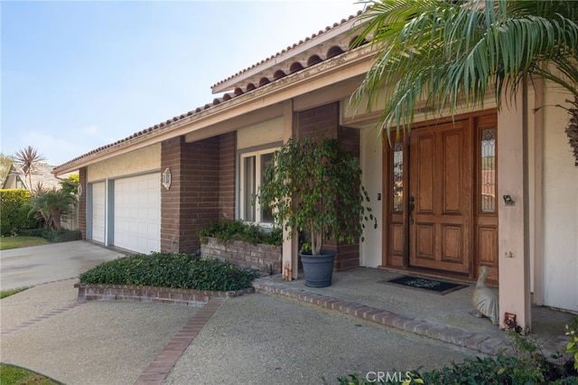 doorway to property with a garage