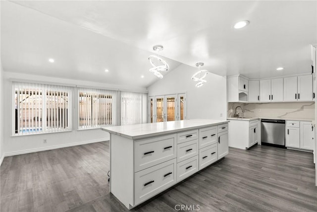 kitchen featuring white cabinetry, vaulted ceiling, dishwasher, tasteful backsplash, and hanging light fixtures