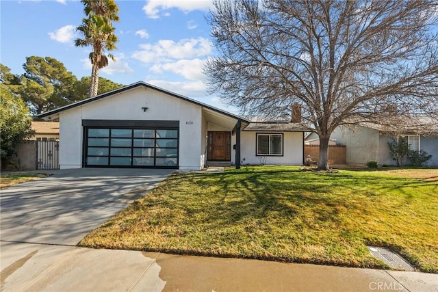 view of front of house featuring a garage and a front lawn