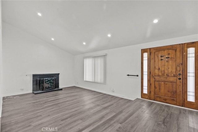 entrance foyer with light wood-type flooring and lofted ceiling