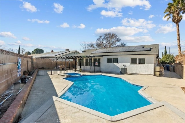 view of pool with central air condition unit, a patio area, and an in ground hot tub