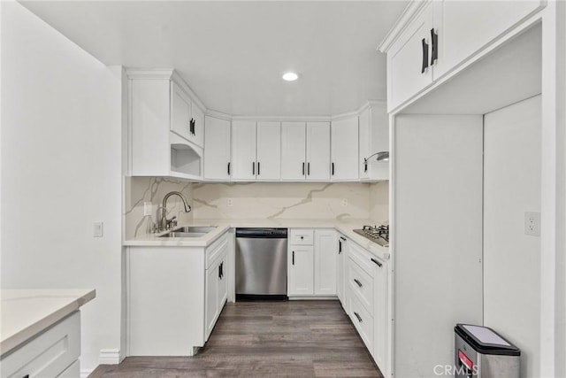 kitchen with sink, white cabinets, tasteful backsplash, stainless steel dishwasher, and dark wood-type flooring