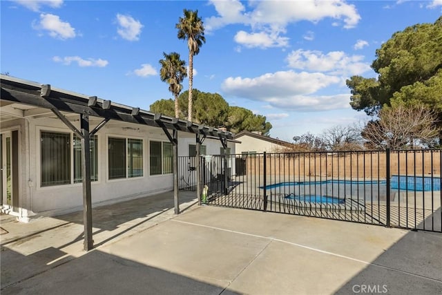 view of gate featuring a patio area and a fenced in pool