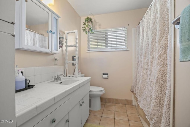 bathroom featuring toilet, vanity, and tile patterned flooring