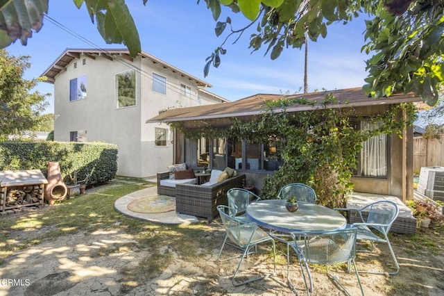 rear view of house with an outdoor living space and a patio area