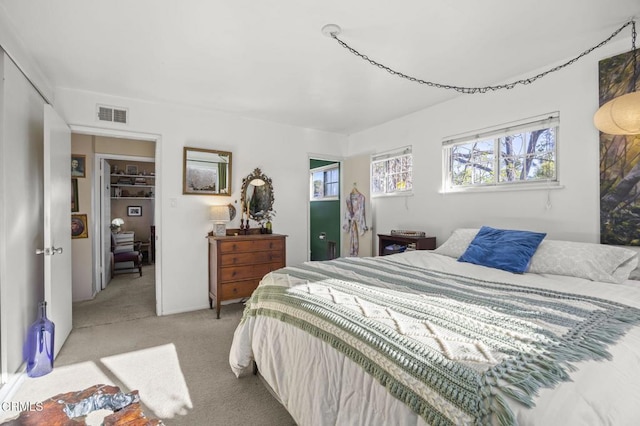 bedroom with light carpet and a closet