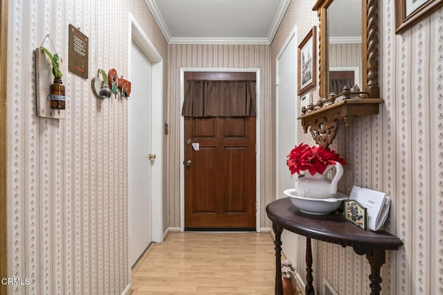 doorway with ornamental molding and light hardwood / wood-style flooring