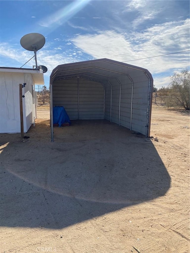 view of parking / parking lot featuring a carport