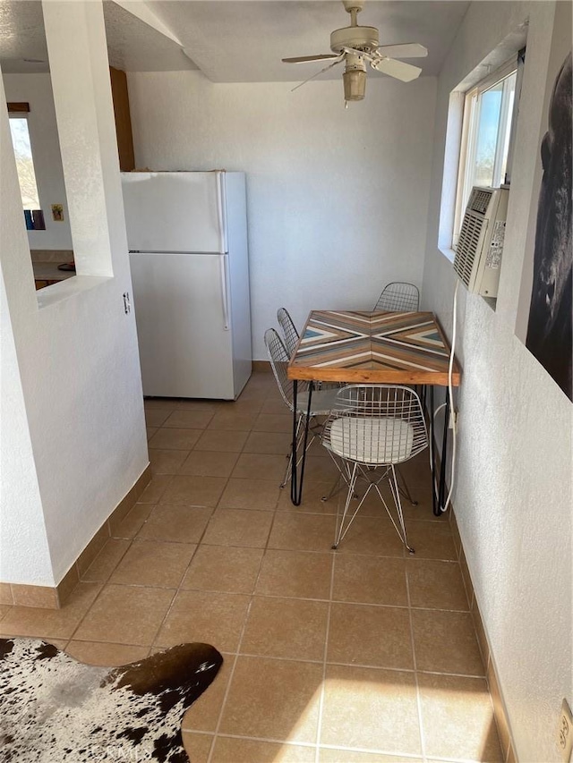 dining space featuring ceiling fan and light tile patterned floors