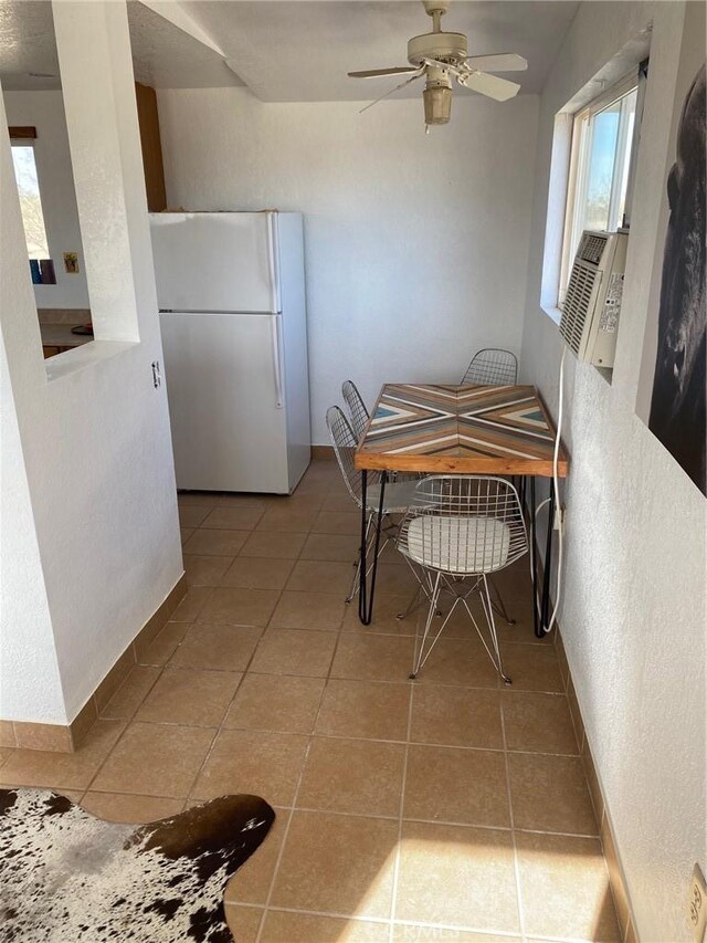 dining area featuring ceiling fan and light tile patterned floors