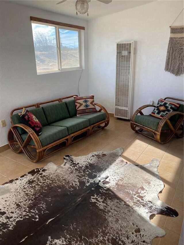 living room with ceiling fan and tile patterned floors