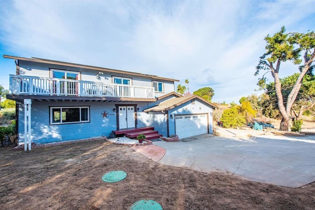 front of property featuring a garage and a wooden deck